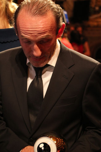 Karl Markovics looking at its prize at the award ceremony of the Zurich Film Festival