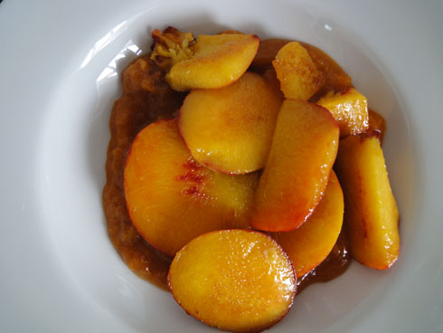 Fried peaches in a bowl on top of an apricot coulis