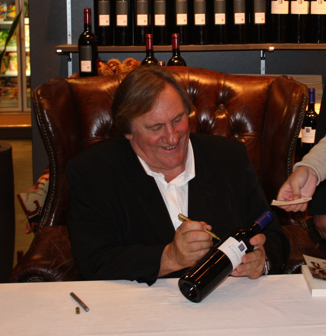 Gerard Depardieu signing a bottle of Confiance at the Globus department store in 2009