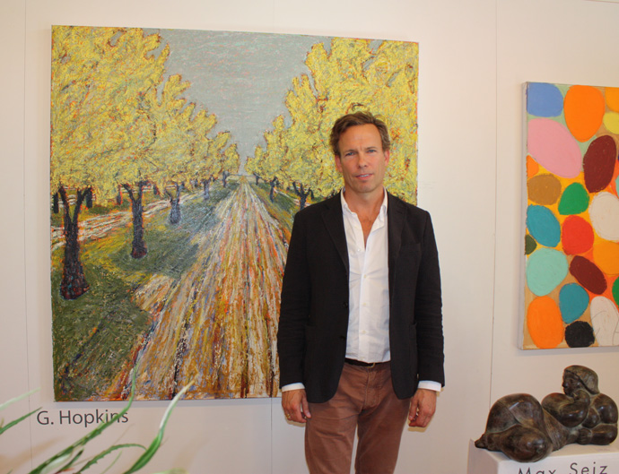 Gordon Hopkins in  front of his painting Orchard in the Luberon