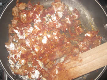 meat, onions with flour and tomato paste