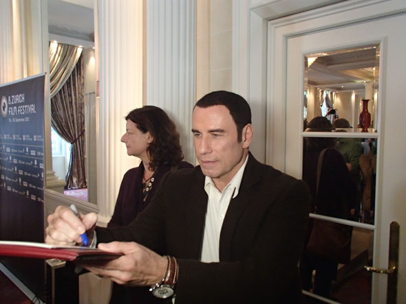 John Travolta leaving the press conference 