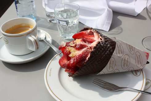 Drinking coffee and eating a strawberry choloate cone at café Landtmann