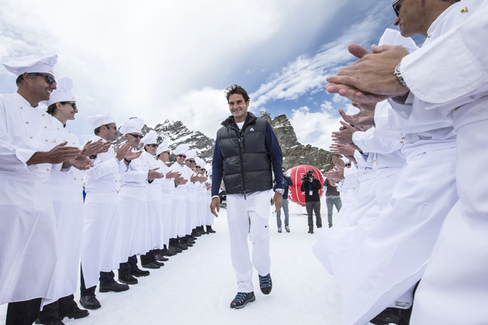 SWITZERLAND JUNGFRAUJOCH ROGER FEDERER LINDT Switzerland's champion tennis player Roger Federer and US champion ski racer Lindsey Vonn played an exhibition tennis match on the Aletsch Glacier below the Sphinx Summit to celebrate the opening of the LINDT Swiss Chocolate Heaven, a shop at 3,454 metres above sea level on Jungfraujoch, Switzerland, on Tuesday, July 16, 2014. The themed chocolate shop, which offers a wide range of the finest LINDT chocolate and the adjacent Master Chocolatiers parlor gives visitors a insight into how chocolate is made, was opened by Roger Federer and is collaboration between Swiss chocolate maker Lindt & Spruengli AG and Jungfrau Railway Holding AG. (PHOTOPRESS/Alexandra Wey) 