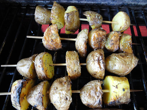 Roasted potatoes on a wodden stick