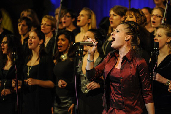 The Gospel and Soul choir singing at the Buehl church in Wiedikon, with Ariane Wildberger (red on the right side)  - credit Voice and Music Academy